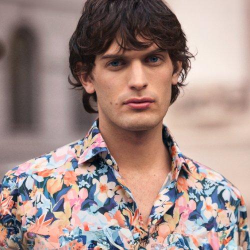 A man wearing a floral print shirt
