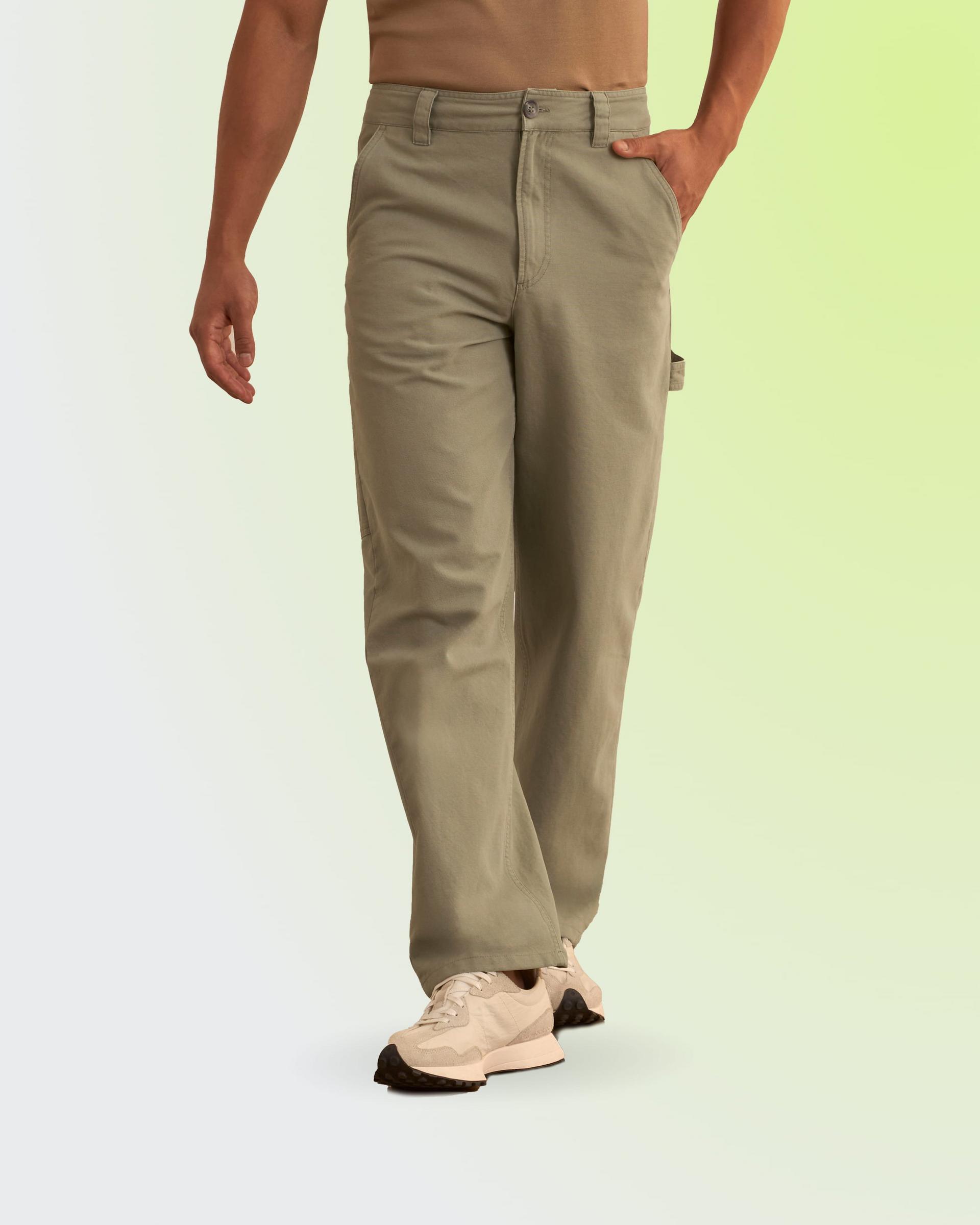 A man wearing beige cargo pants paired with light-colored sneakers