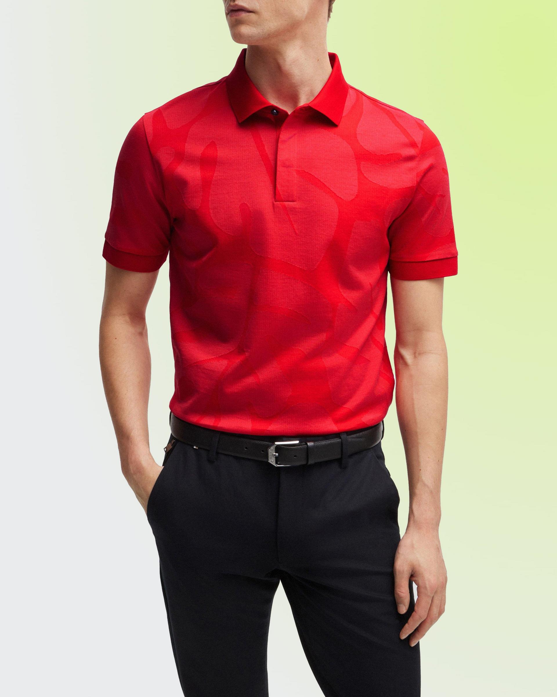 A man wearing a Polo t-shirt in a vibrant red color with black pants