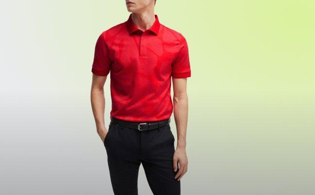 A man wearing a Polo t-shirt in a vibrant red color with black pants