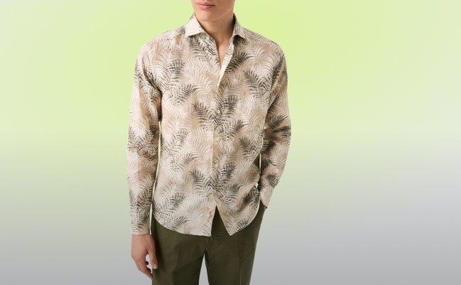 Model wearing Eton Motif Linen Shirt in a beige leaf print and green pant