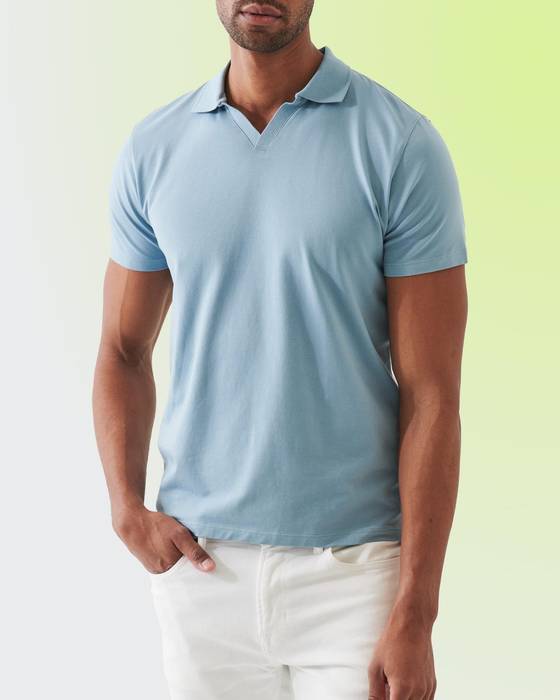 A man wearing a light blue t-shirt with white pants