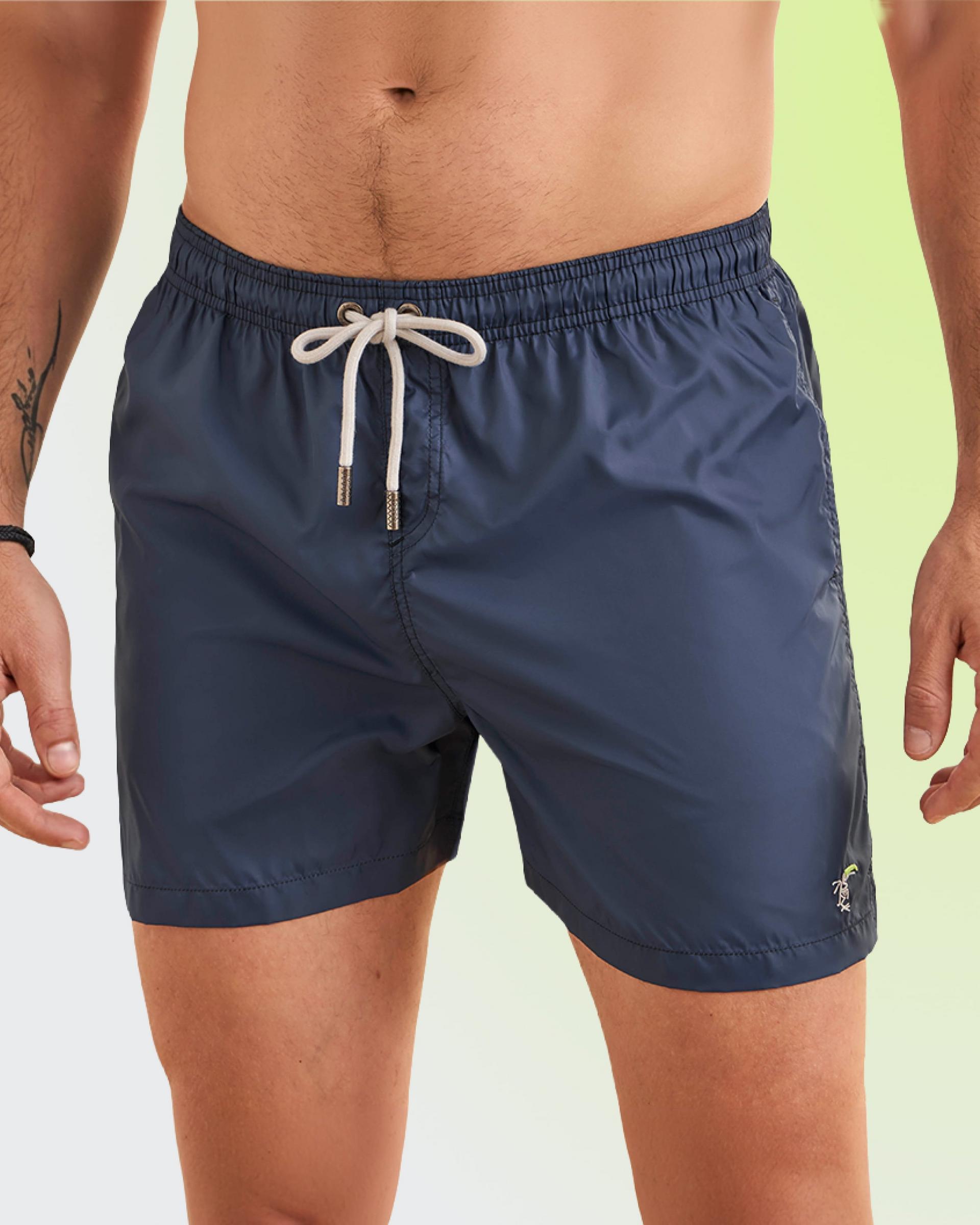 A man wearing a navy-blue swimwear shorts