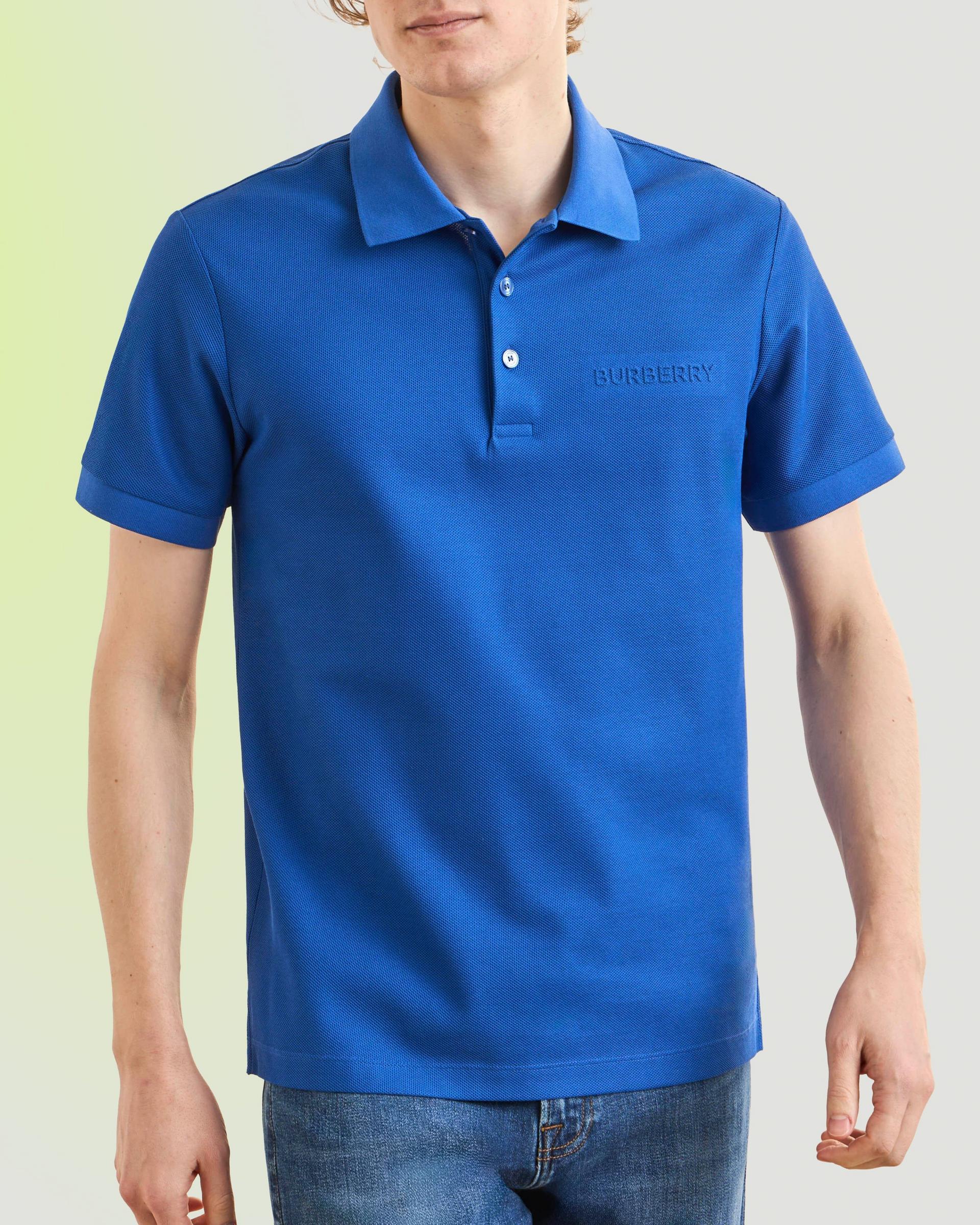  A man wearing a bright blue short-sleeve polo shirt with a small, embroidered Burberry logo on the chest