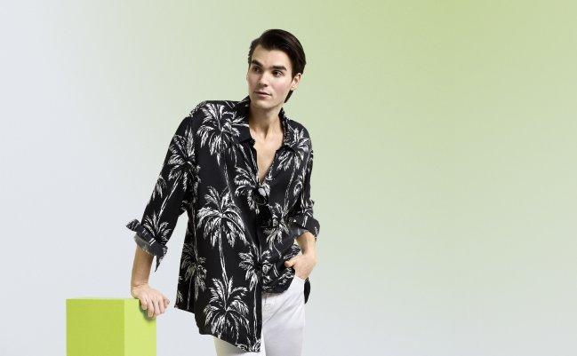 A man wearing a black and white printed casual shirt