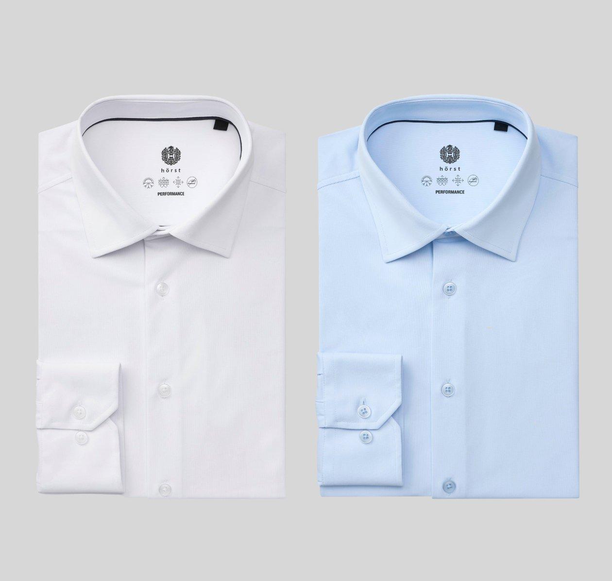 A white and light blue performance dress shirt styled on a grey background