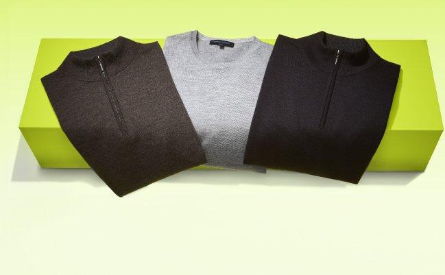 Patrick Assaraf sweaters styled on a bright green display