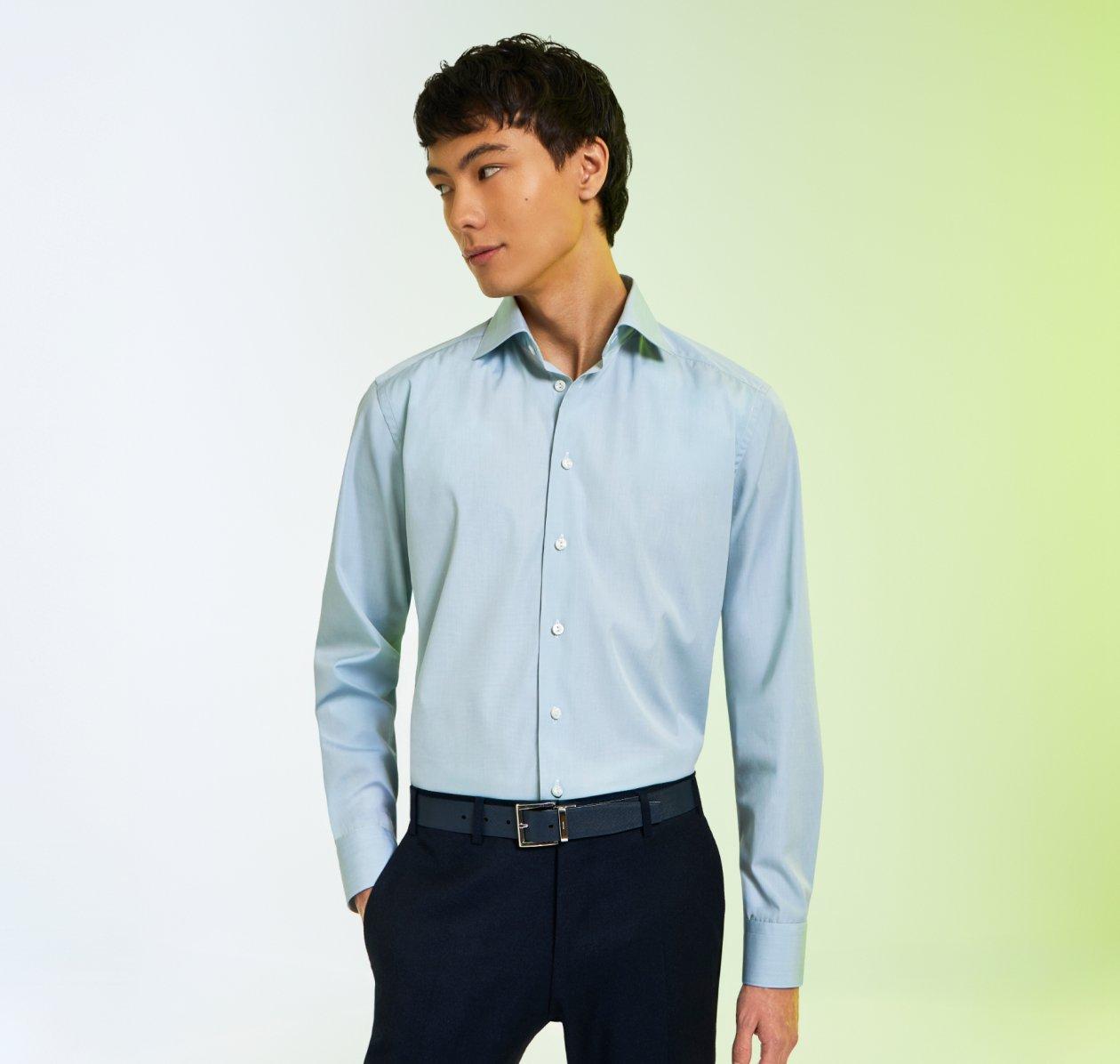 A male model wearing a blue casual shirt