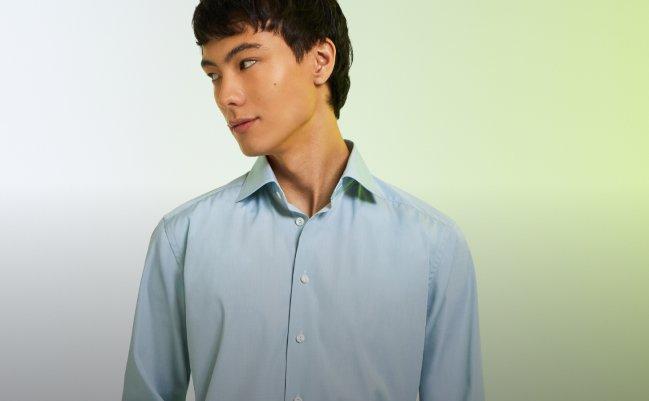 A male model wearing a blue casual shirt