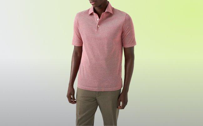 A man wearing a pink polo t-shirt with light brown pant