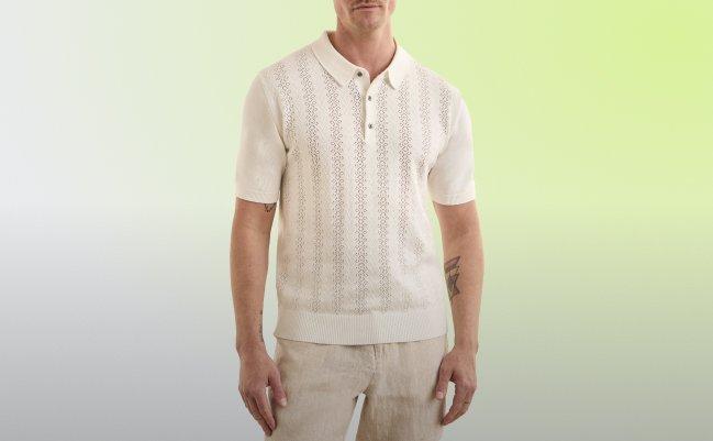 Un homme portant un polo blanc cassé et un pantalon