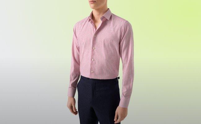 A man wearing a pink polo t-shirt with light brown pant
