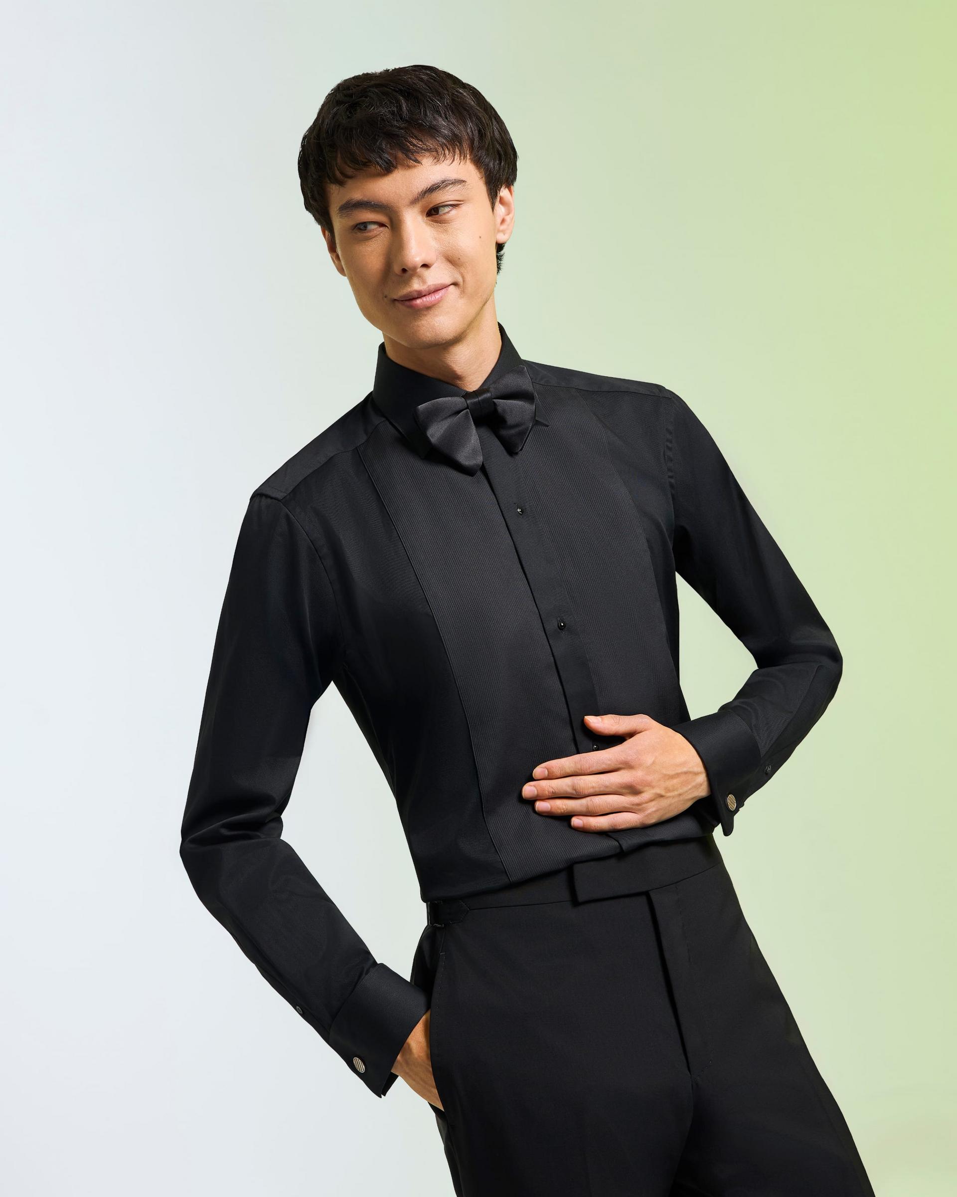 a male model wearing a blakck dress shirt and bowtie