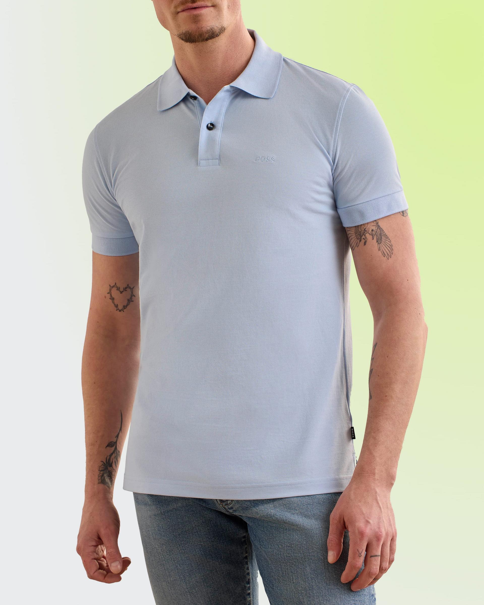 A model wearing a light blue BOSS polo shirt paired with denim