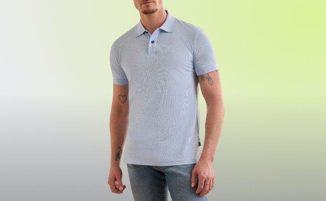 A model wearing a light blue BOSS polo shirt paired with denim