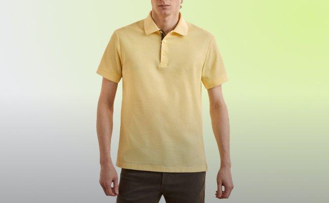 Model wearing a yellow polo shirt 