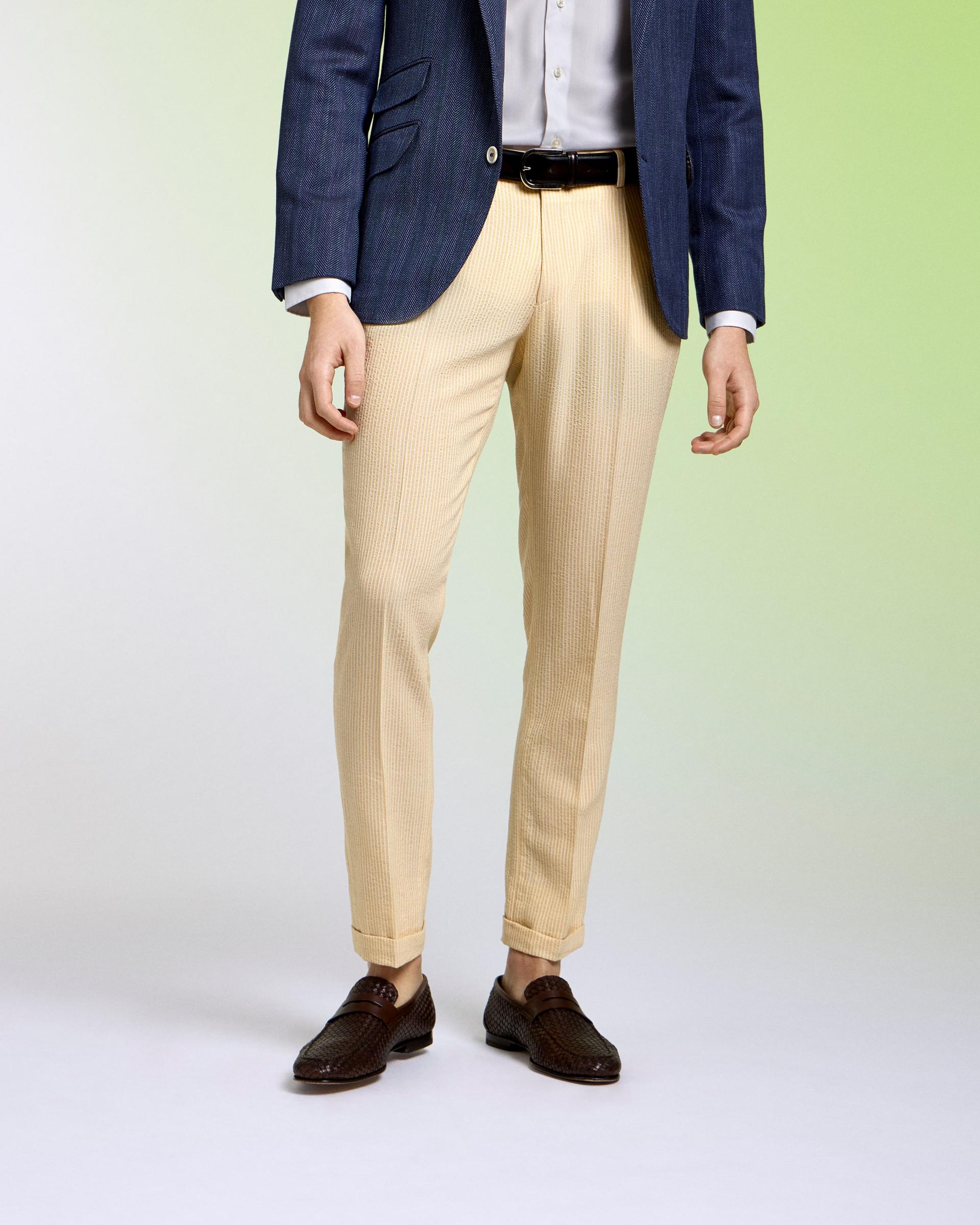 model wear beige pants and a navy sports jacket