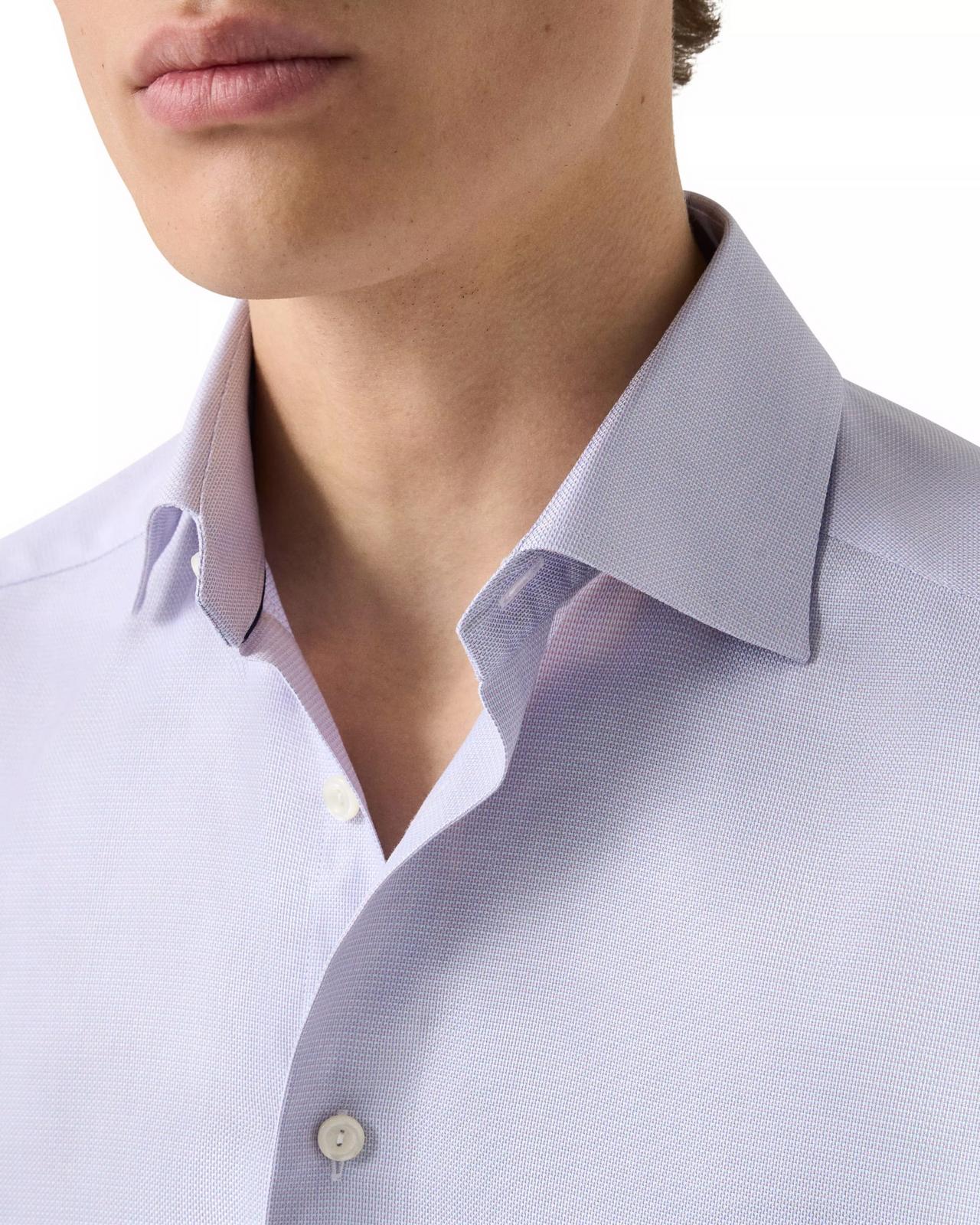 close-up shot of model wearing light blue dress shirt with cutaway collar