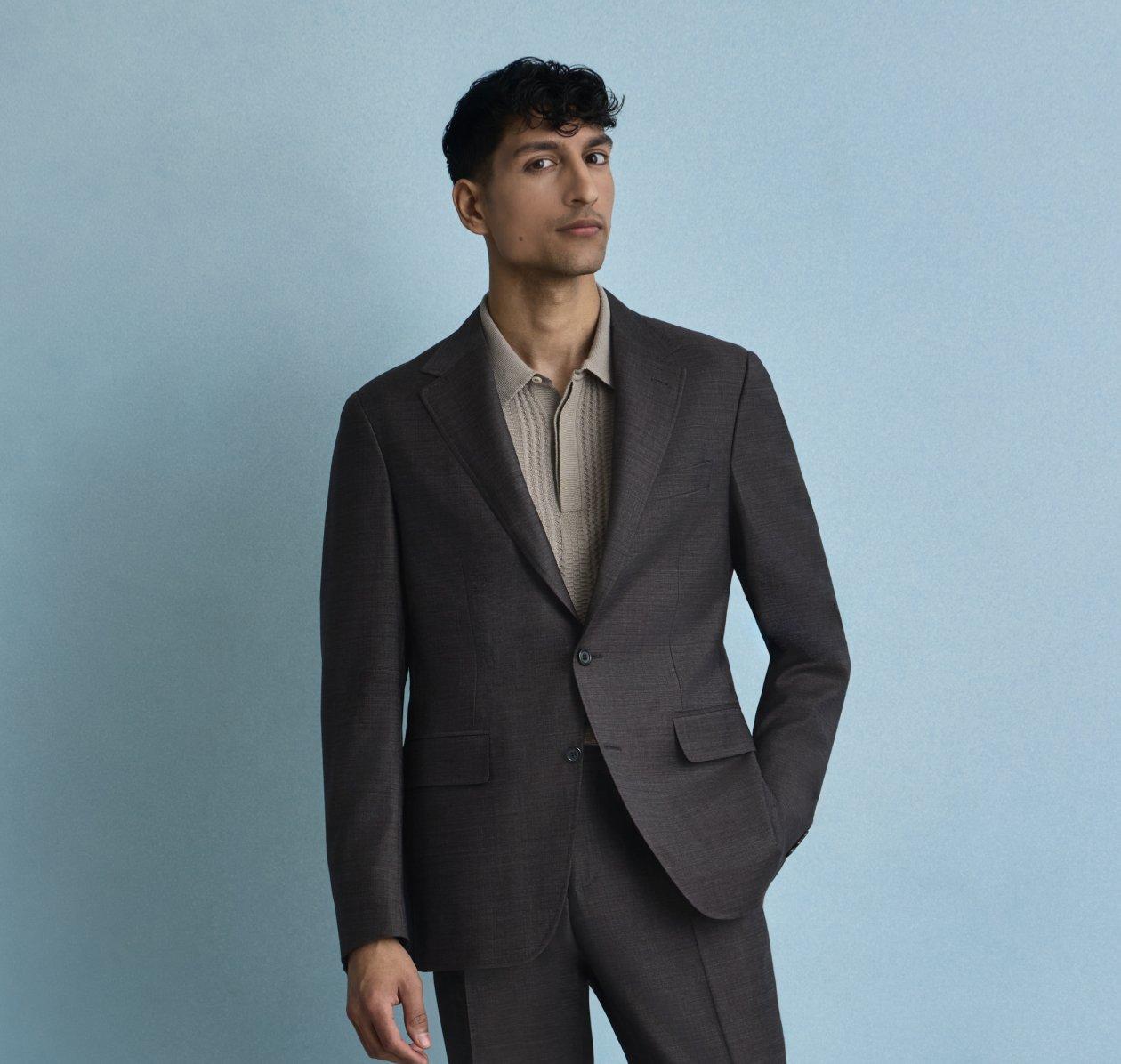 A man wearing Canali's coat and pant with polos