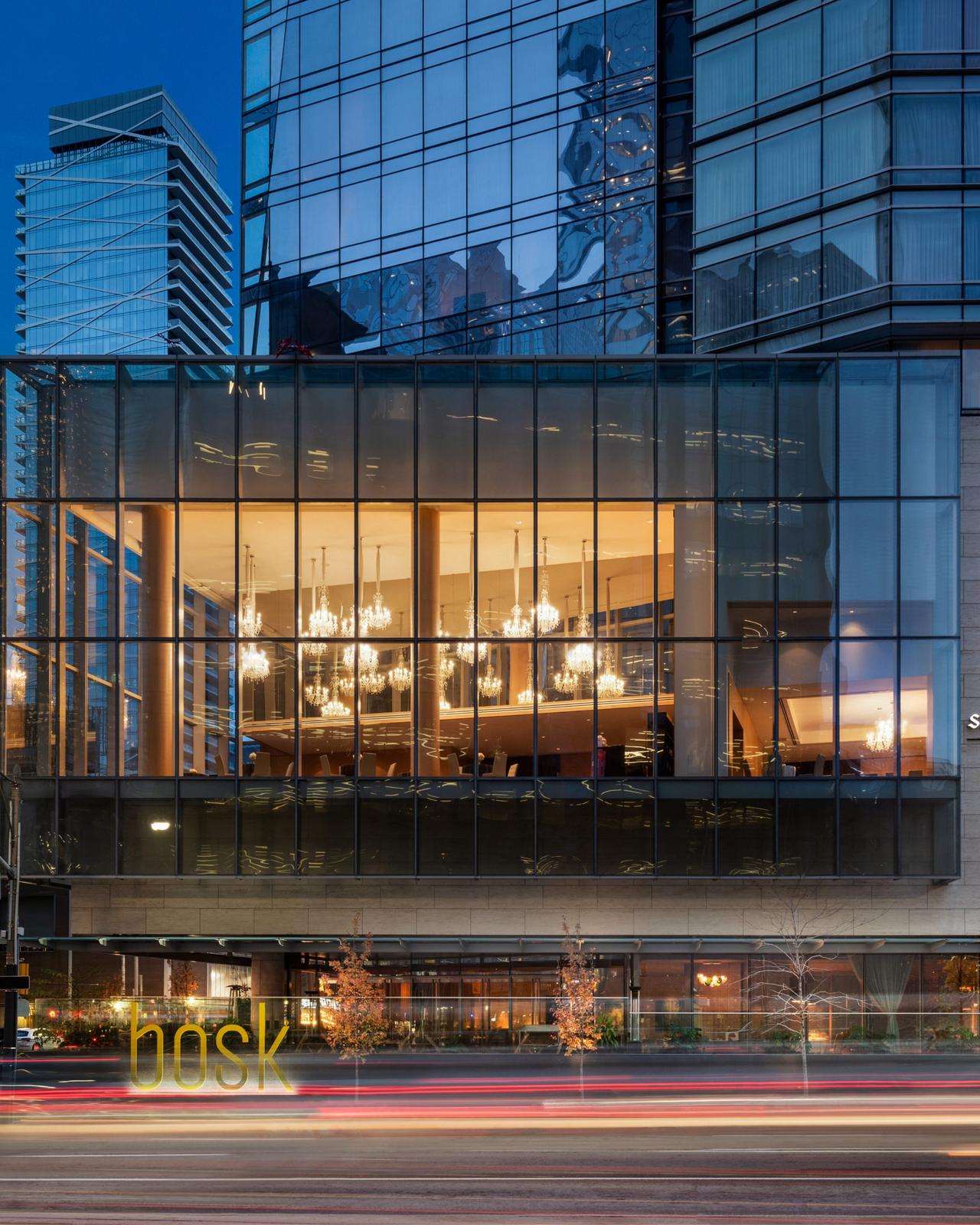 Telus Building at 25 York Street in Toronto, showcasing its sleek glass façade and warmly lit interior dining area