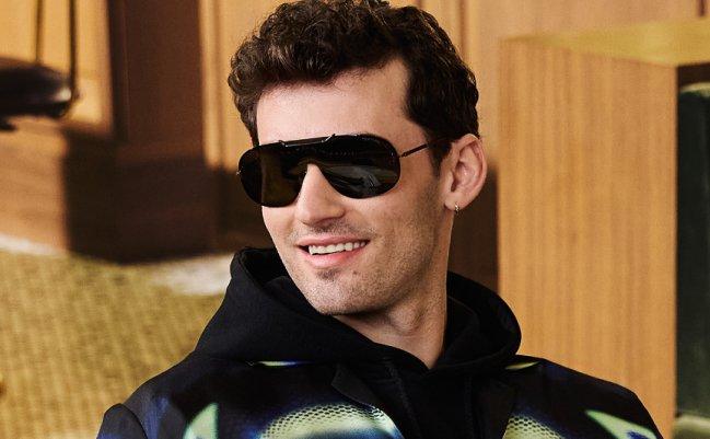 A man wearing round black sunglasses