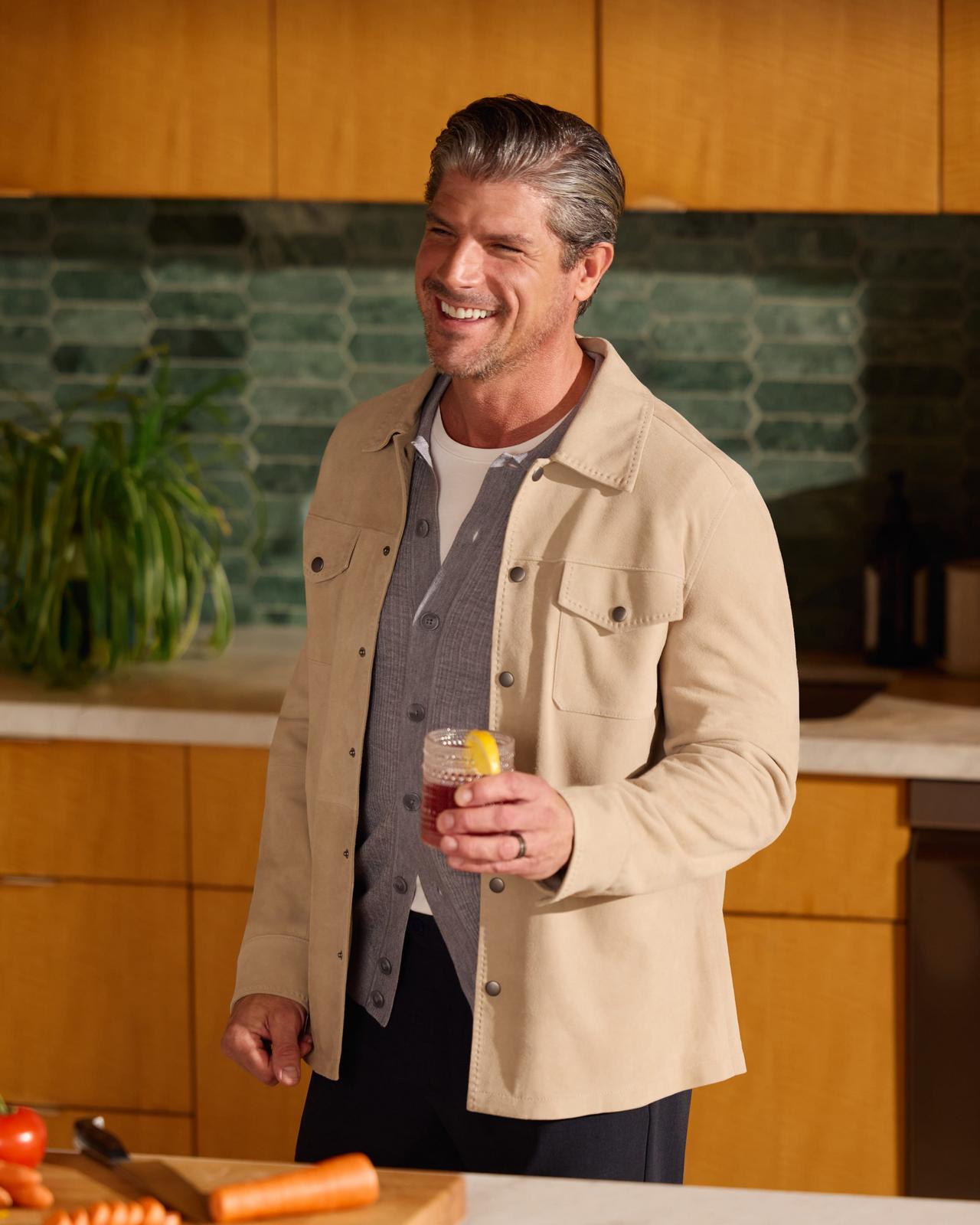 Mannequin masculin portant une surchemise couleur crème, un chandail en tricot gris à glissière et un pantalon noir