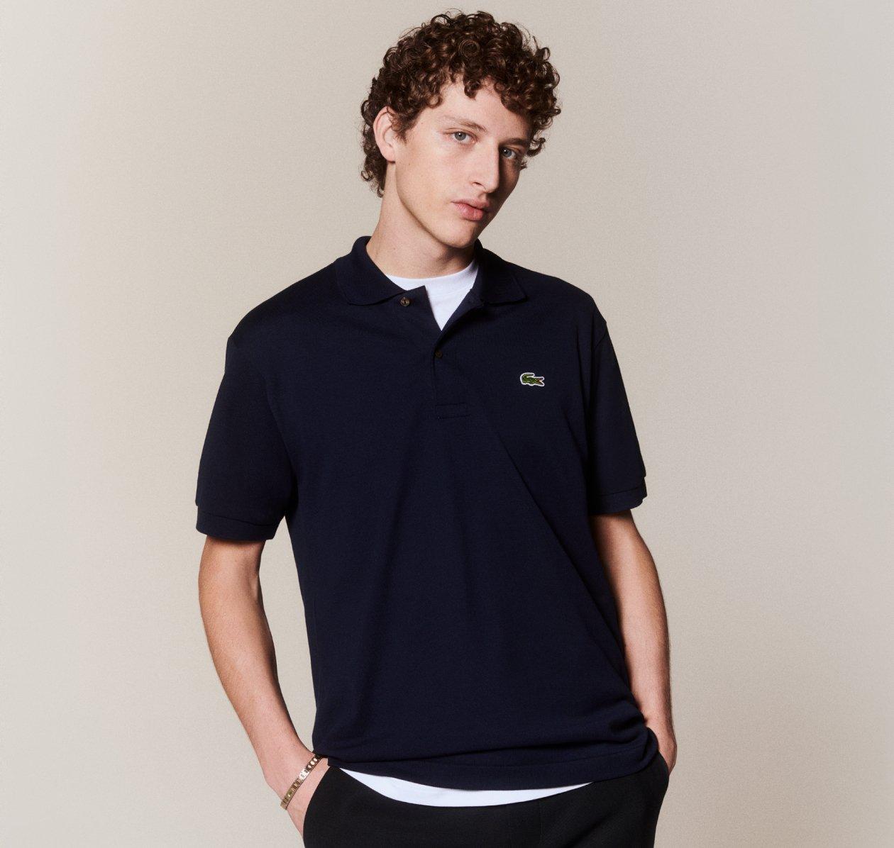 A man wearing a black v-neck t-shirt from Lacoste