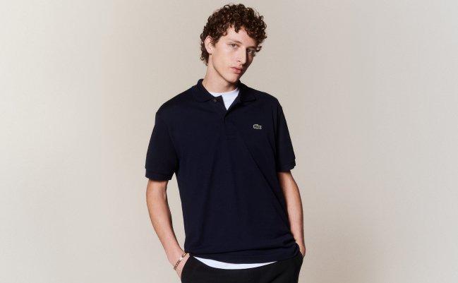 A man wearing a black v-neck t-shirt from Lacoste