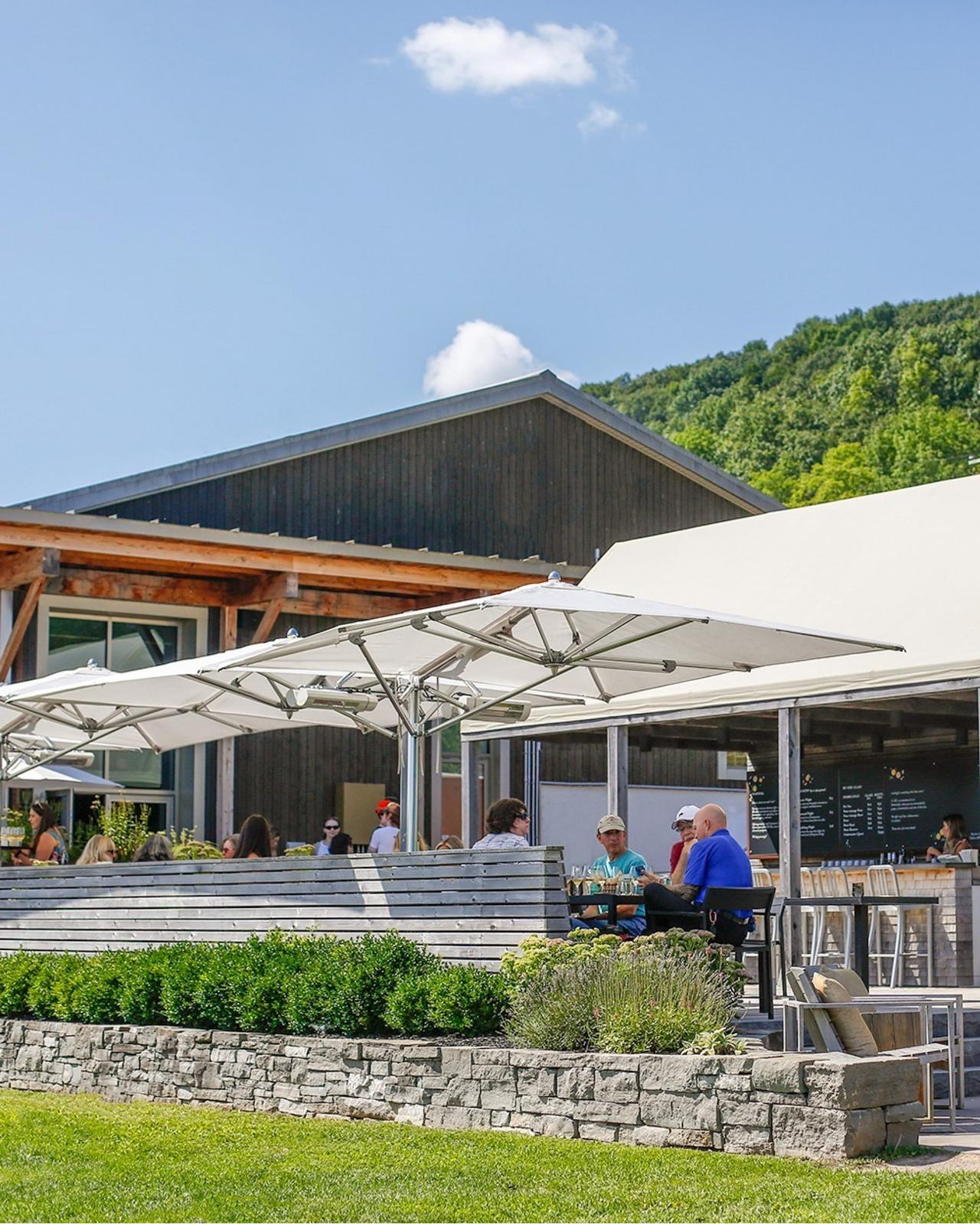 Guests enjoying a wine tasting experience in an outdoor patio setting