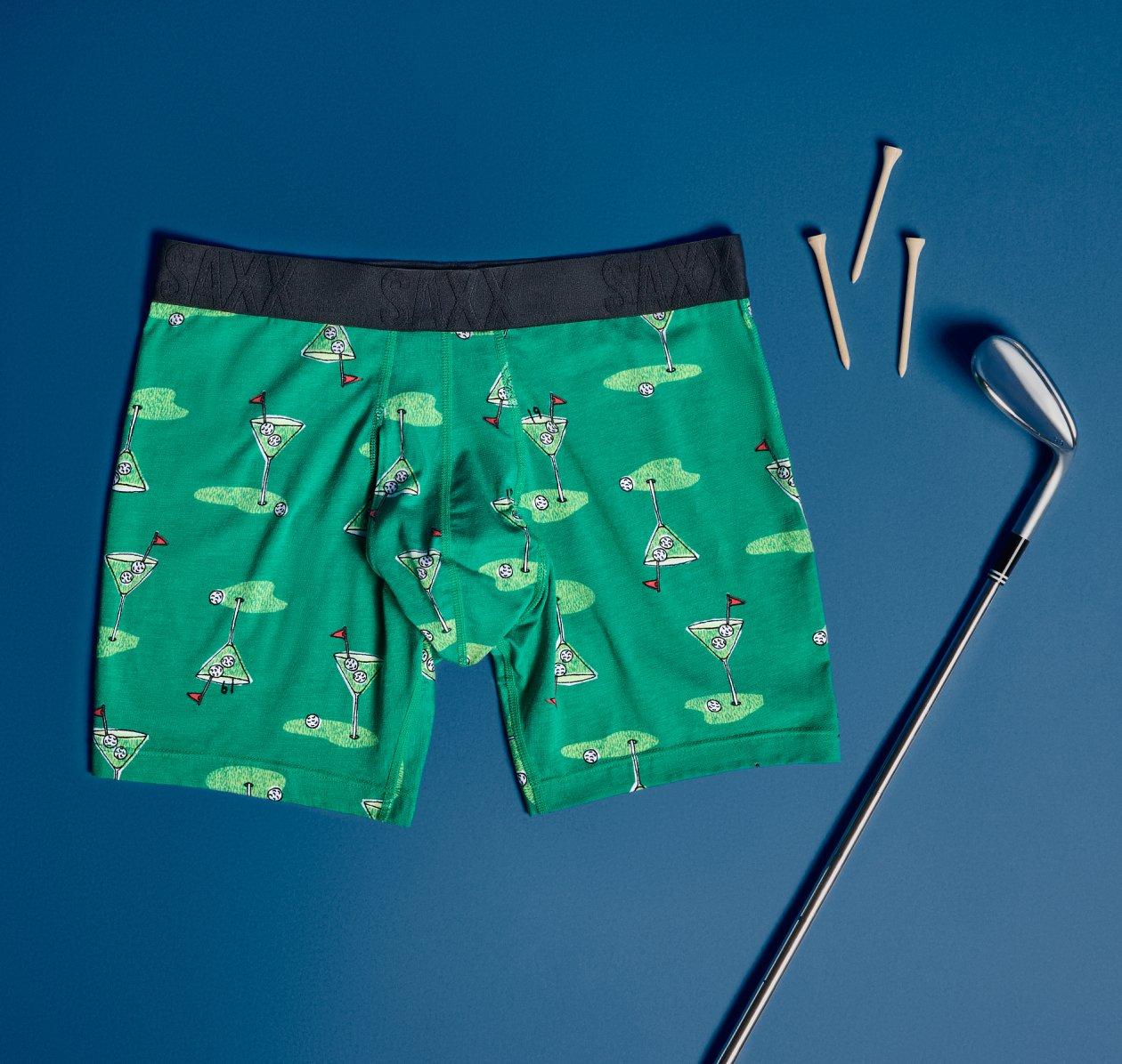 SAXX green boxer briefs featuring a black waistband and a golf-inspired print of martini glasses, golf balls, and flags