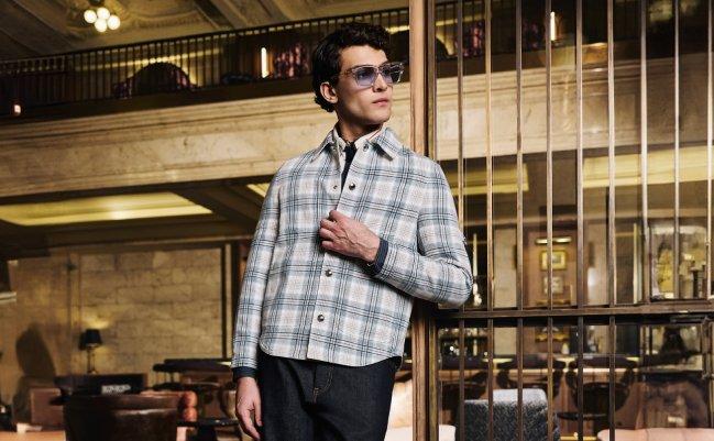 A man wearing an off-white check patterned shirt with black pant