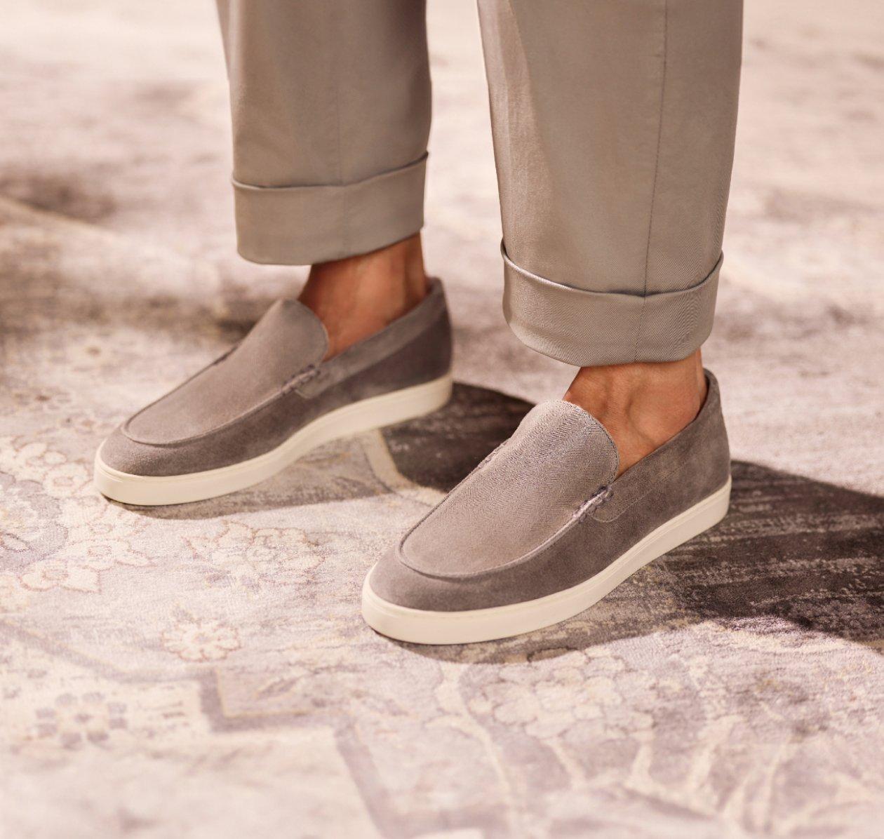 A man wearing light brown loafers