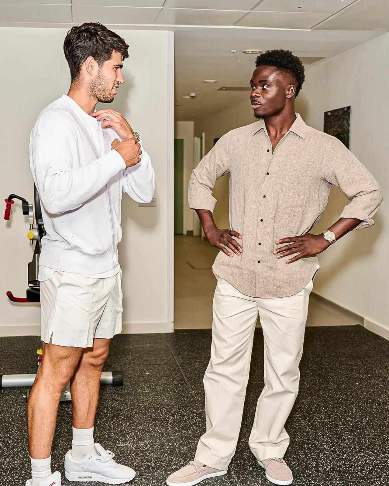 Two mens wearing shorts with white and trousers with beige shirt 