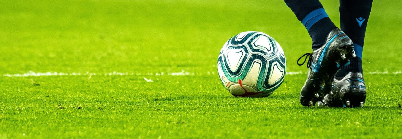 Football on the ground with player