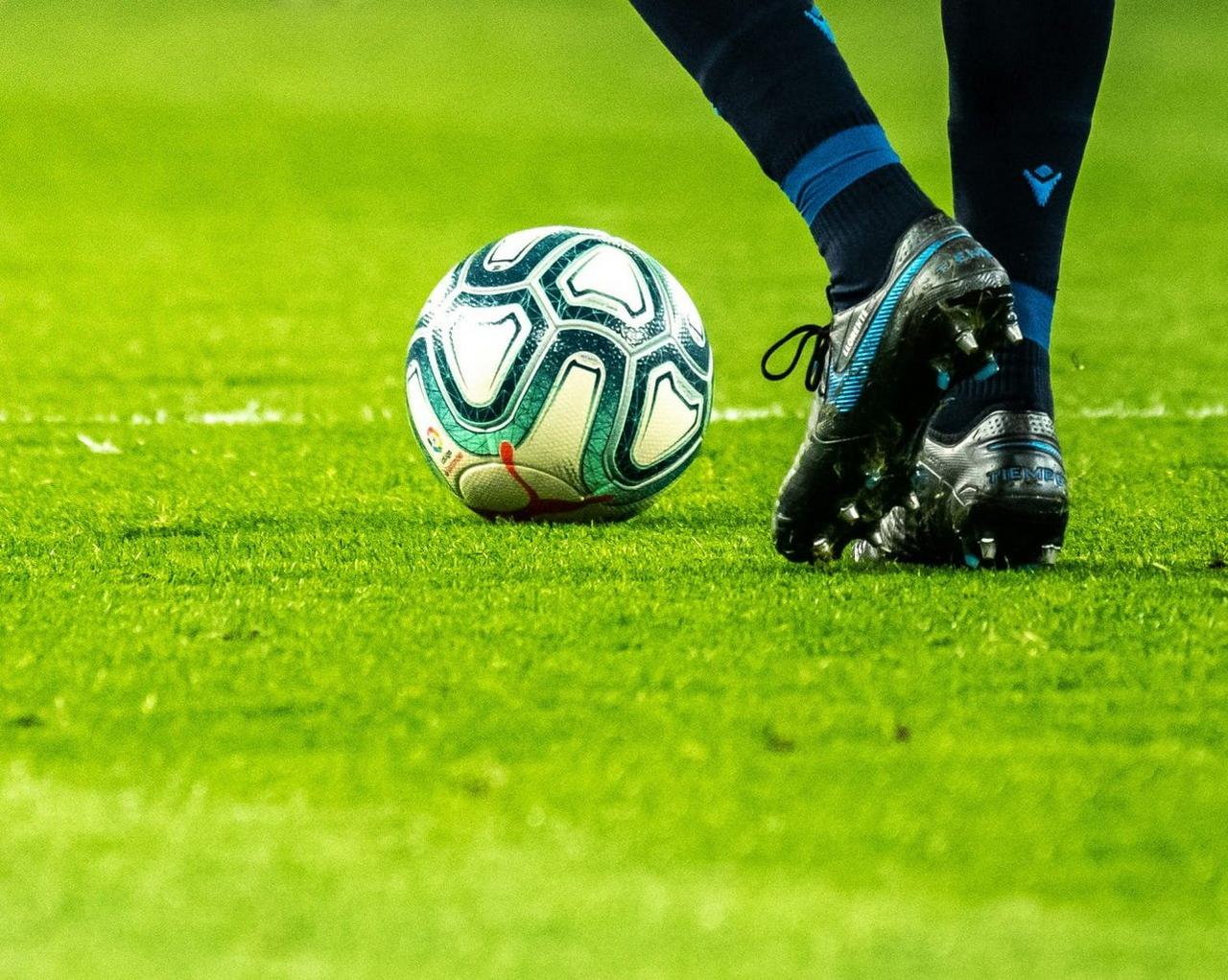 Football on the ground with player