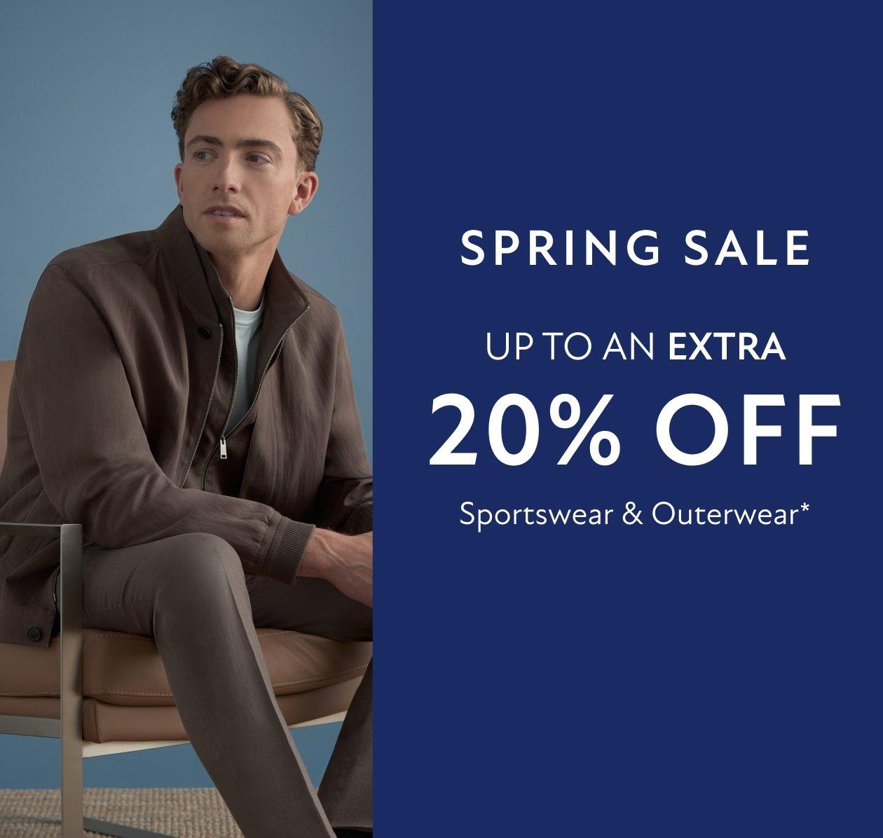 A man wearing a dark brown light jacket, light blue t-shirt and grey brown pant