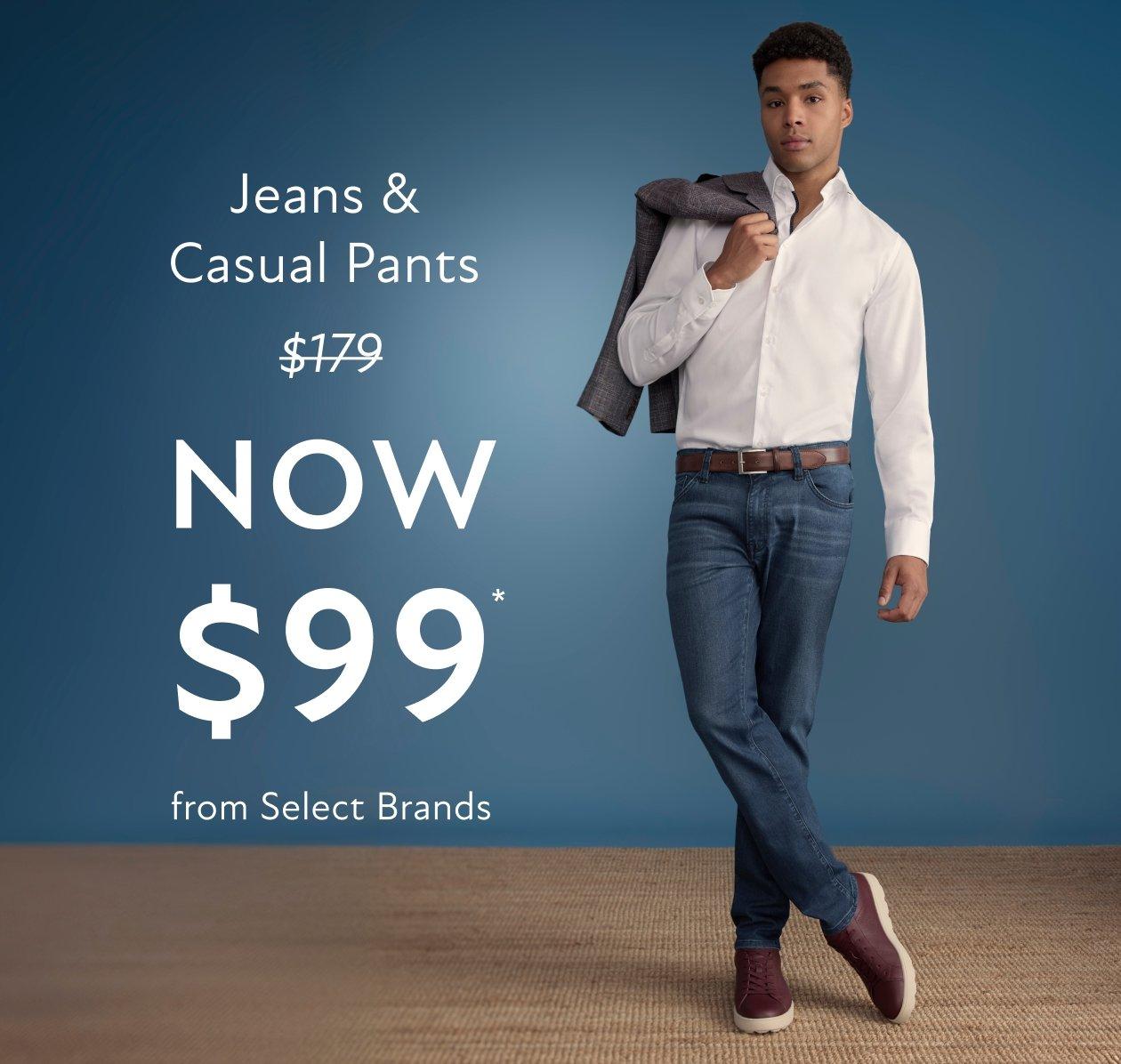 A man wearing a white shirt and dark blue jeans with brown sneakers