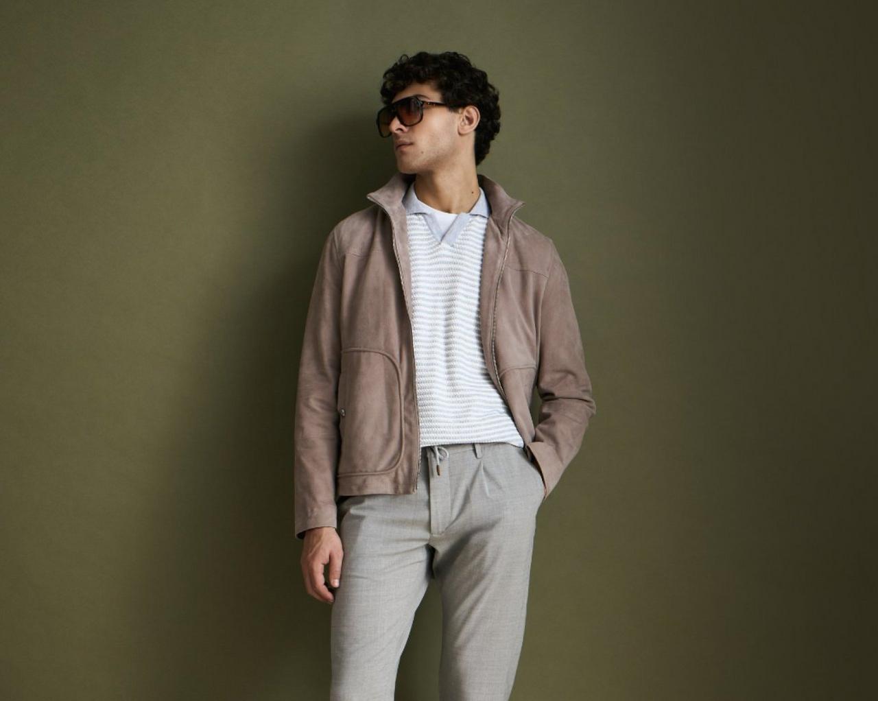 A man wearing a clay overshirt with cool silver polo t-shirt, dark brown shades and gray pants