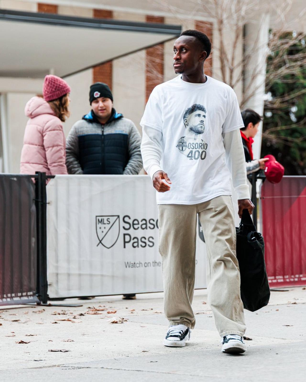 Richie wearing a graphic t-shirt with beige relaxed fit pant
