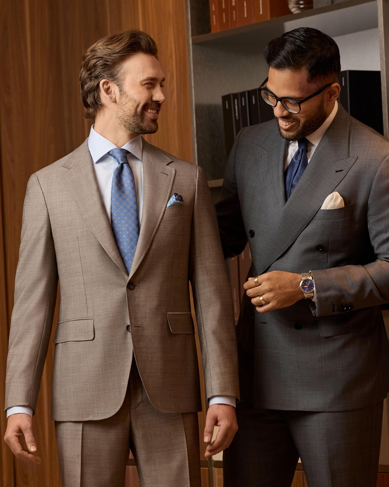 Mens wearing custom made suits near the mirror