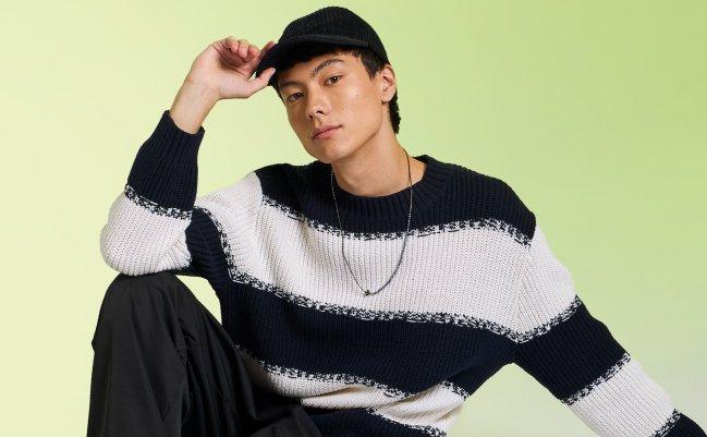 A male model wearing a knit sweater