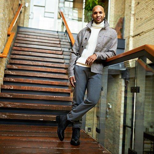 male model leaning on staircase banister