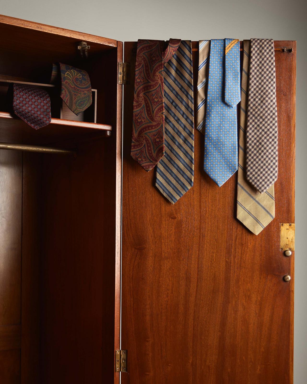 Ties displayed on closet door illustrating a look inside Harry's closet