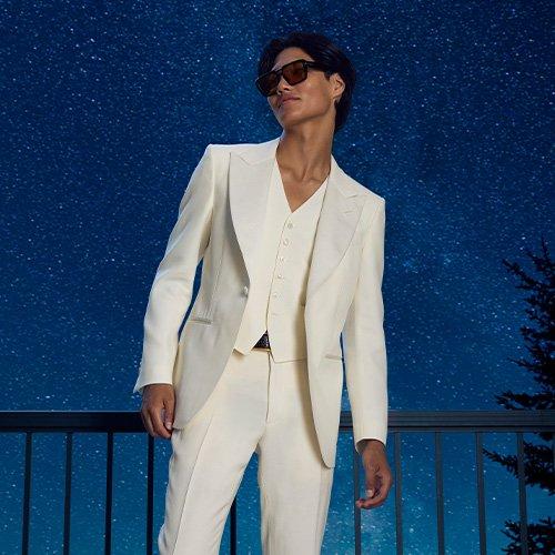 man wearing white suit with stars in background