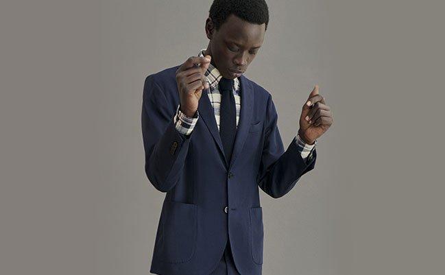A man wearing a navy blue BOGLIOLI suit with a tie