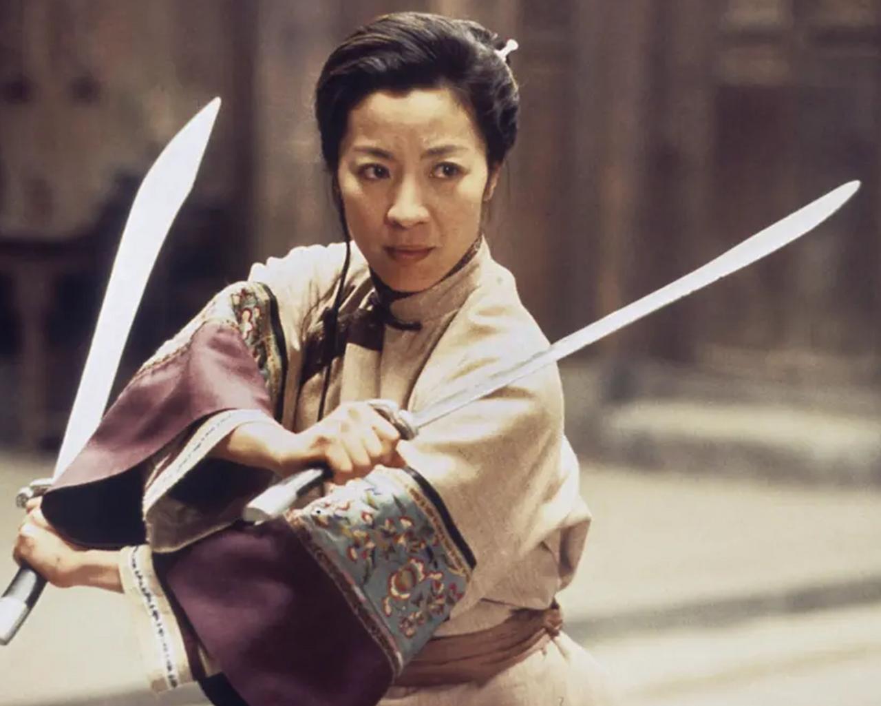 A scene from the 2000 film Crouching Tiger, Hidden Dragon showing a woman holding a sword in combat pose