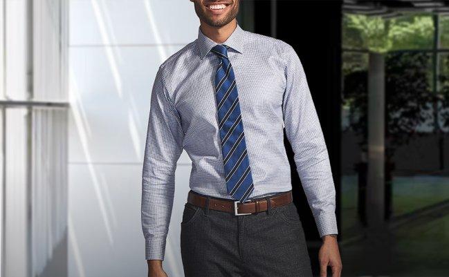 Male model wearing a blue dress shirt walking down the street