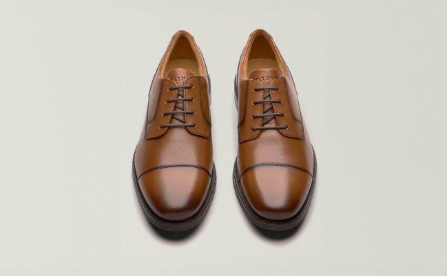 A display showcasing a pair of Cole Haan dress shoes