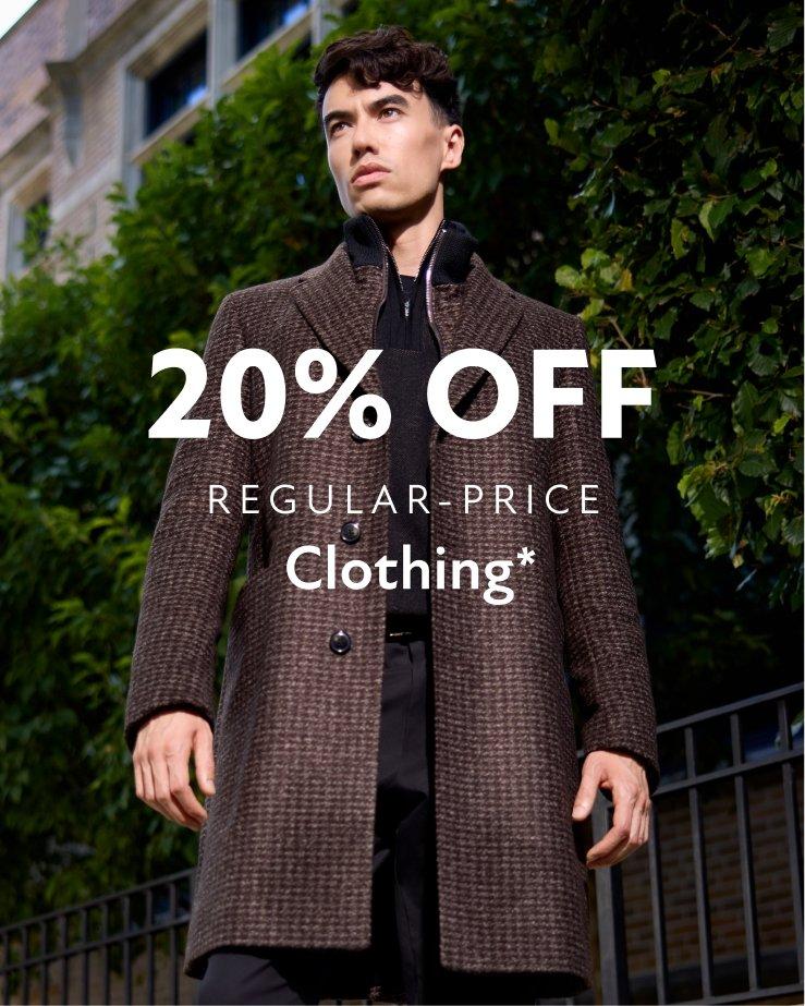 A man wearing a brown check pattern coat with black sweater and pants