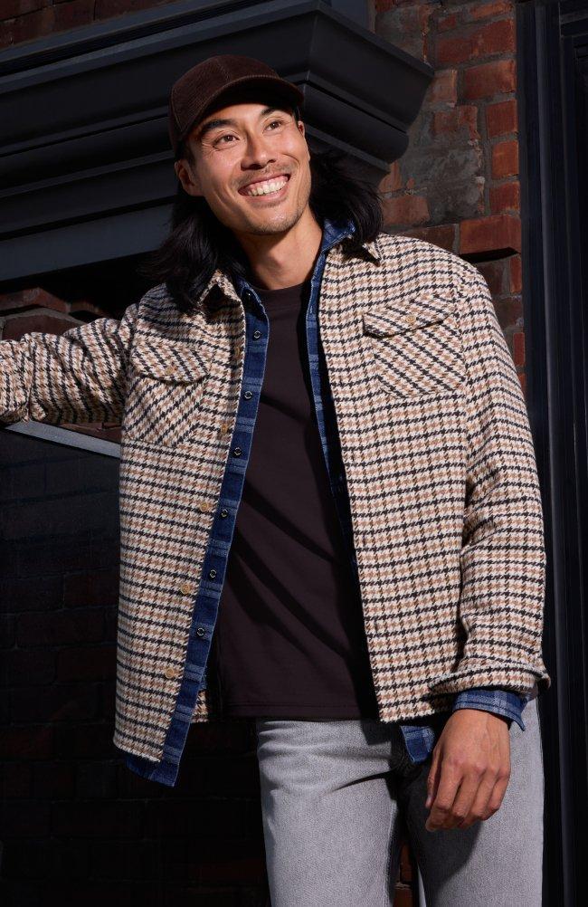 Model wearing a checkered overshirts